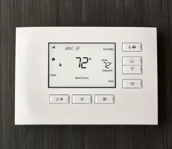 Control4 smart thermostat interface installed on a wood wall