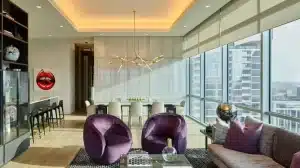 Modern living and dining space with coordinated lighting and motorized shades