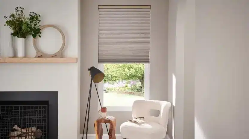 Lutron Triathlon honeycomb shade installed above a fireplace