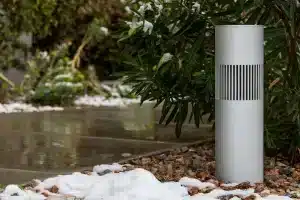Origin Acoustics landscape bollard speaker installed beside a snowy path