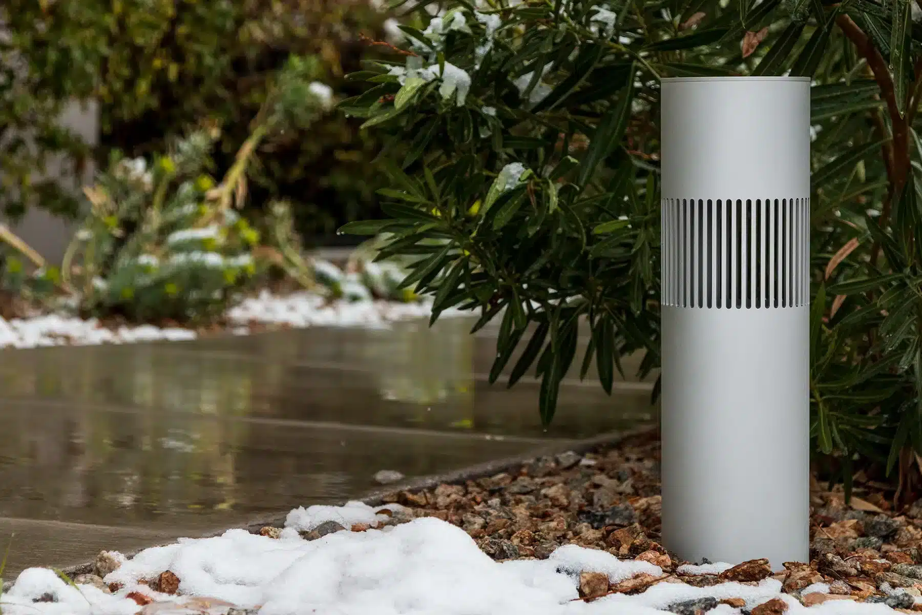 Origin Acoustics landscape bollard speaker installed beside a snowy path