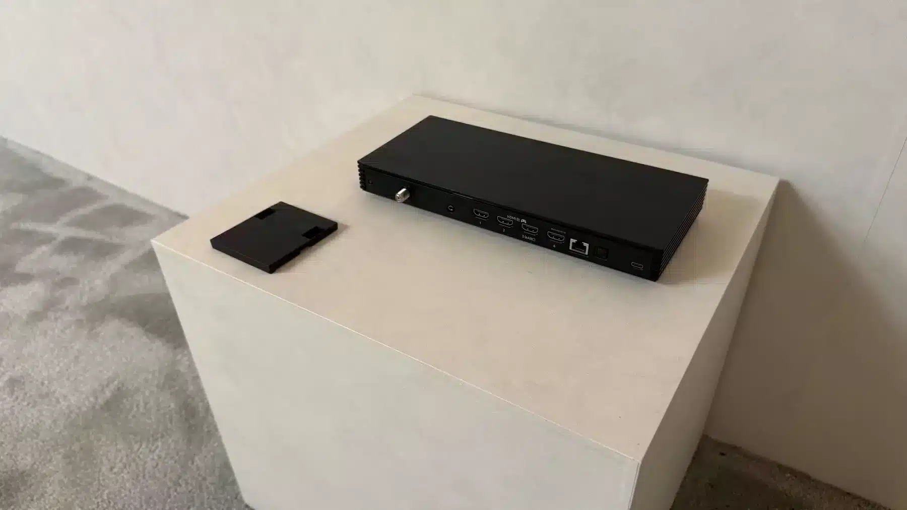 Samsung Wireless One Connect accessory displayed beside a 2026 television demonstration